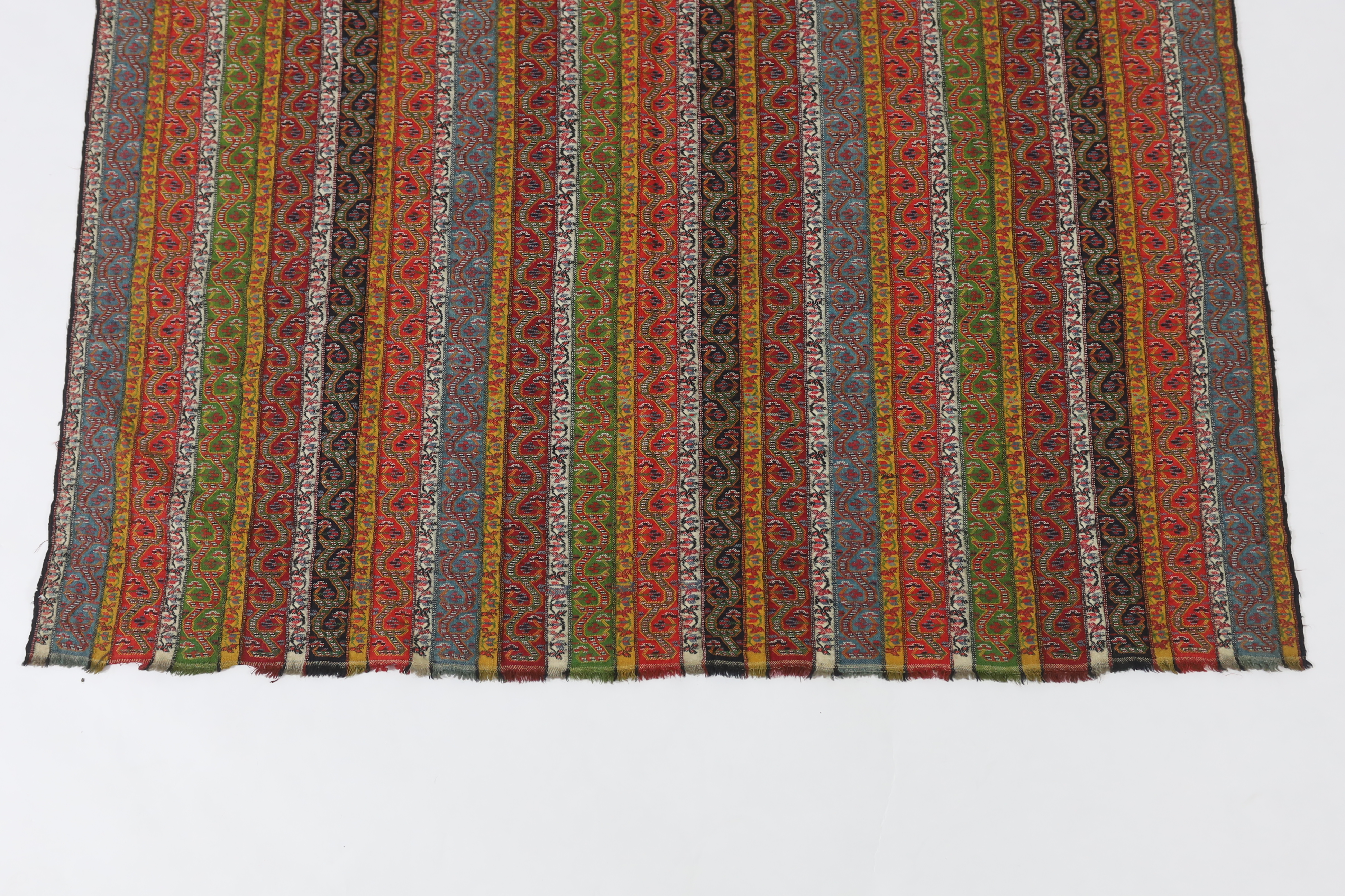 A 19th century Kashmir, multi coloured, striped twill, woven wool shawl, with the fringe cut one end, 140cm long x 114cm wide